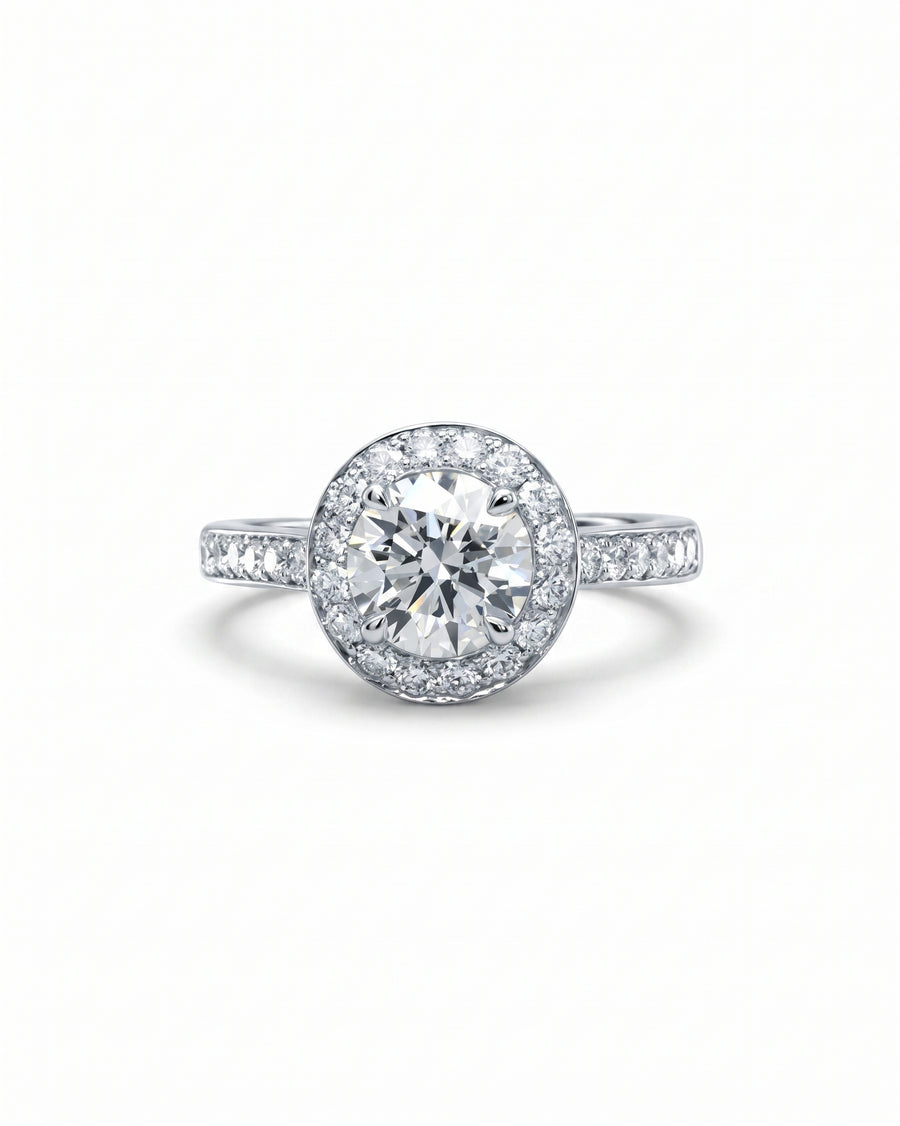 Silver engagement ring with a round diamond cluster and pavé band.