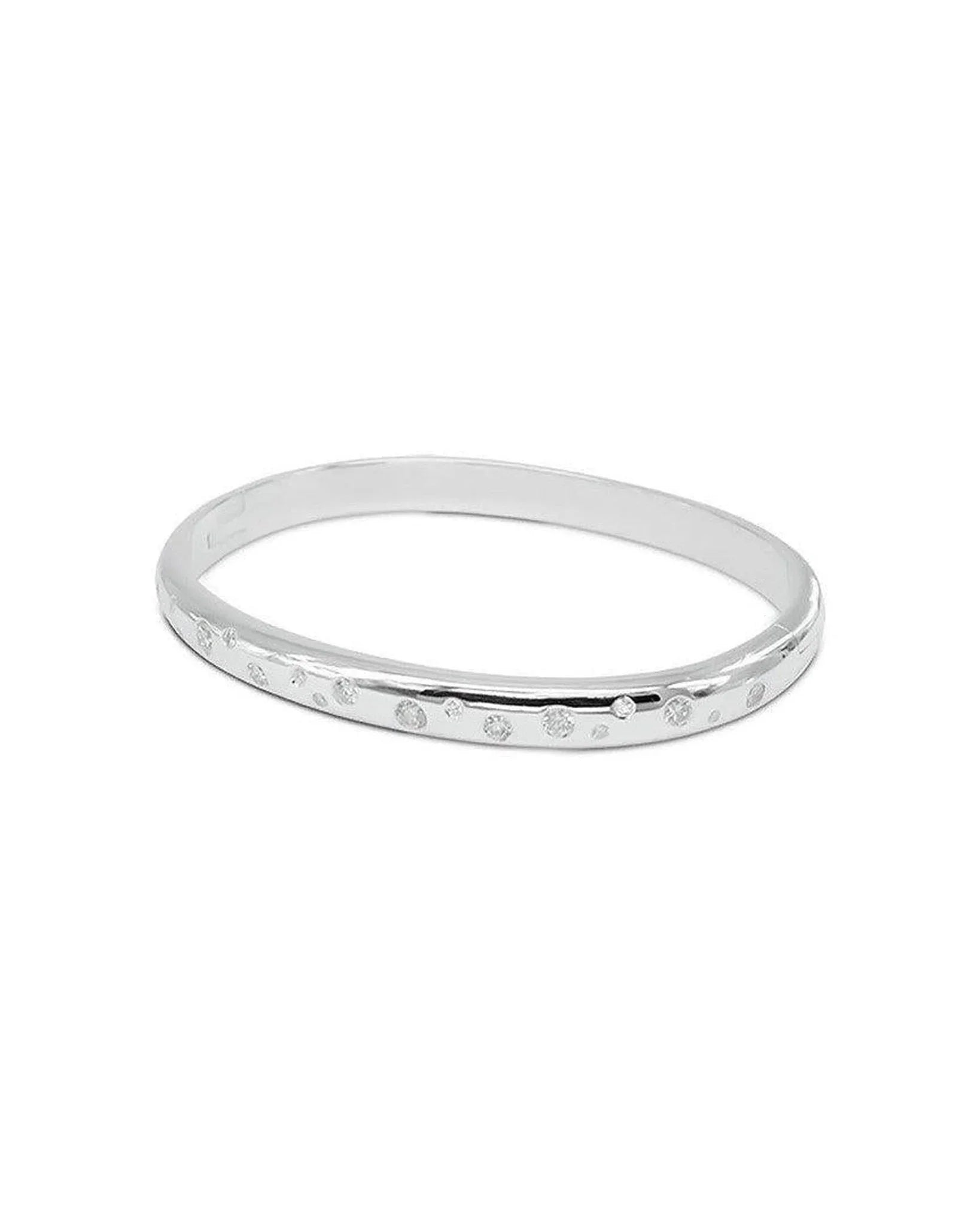 Solid silver hinged bangle with randomly scattered diamonds on one side.