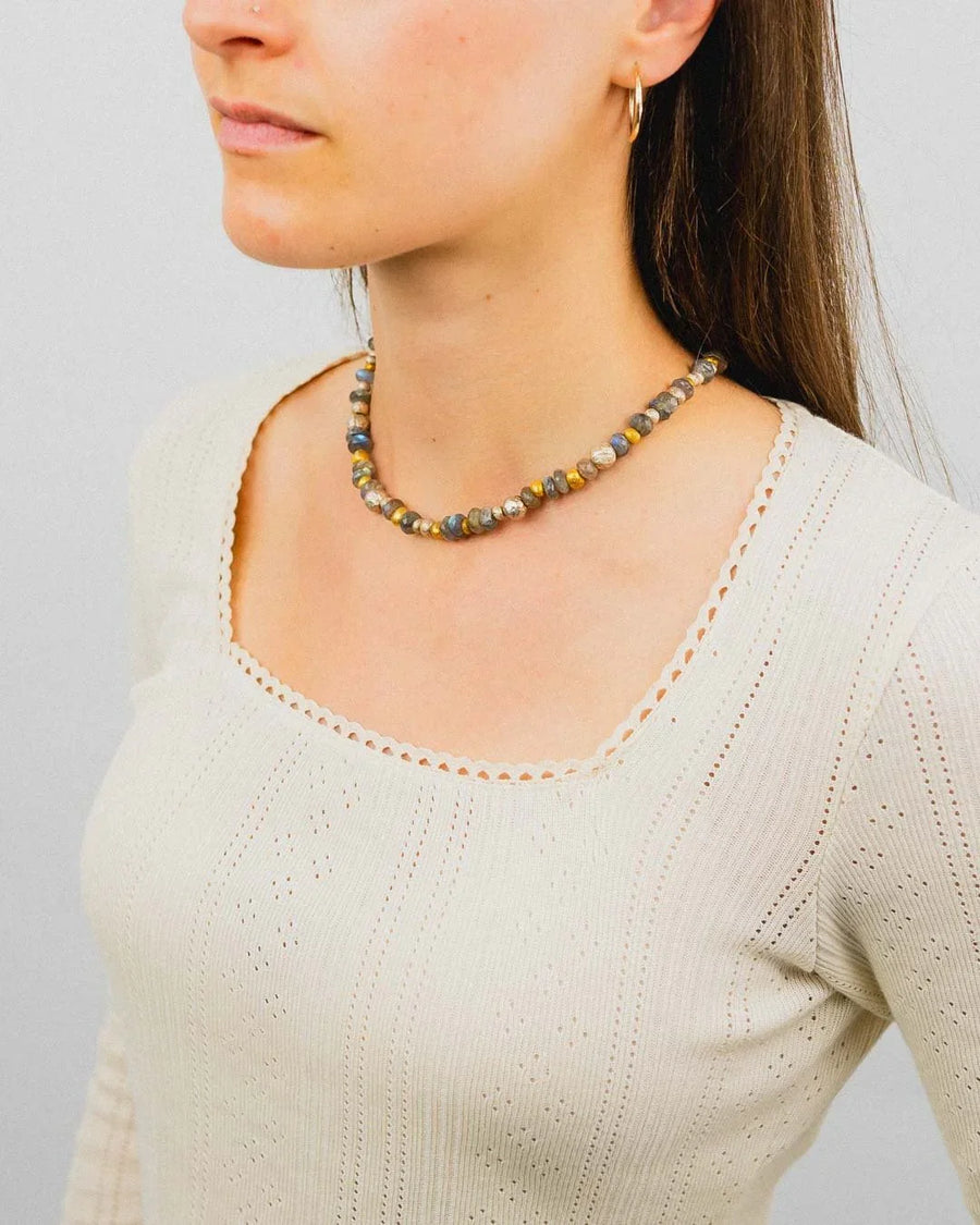 Woman wearing a labradorite, silver, and gold nugget beaded necklace