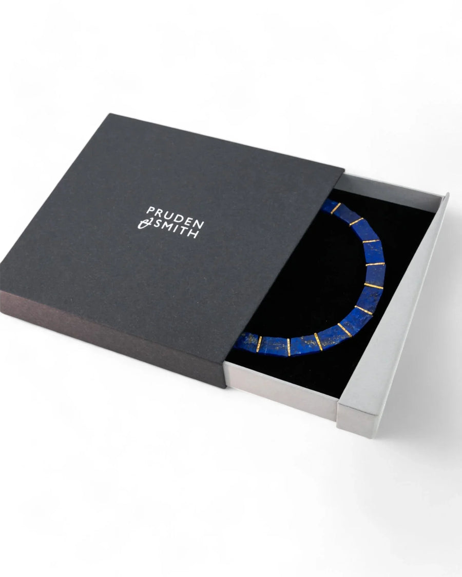 Lapis lazuli collar necklace with gold accents in a black gift box