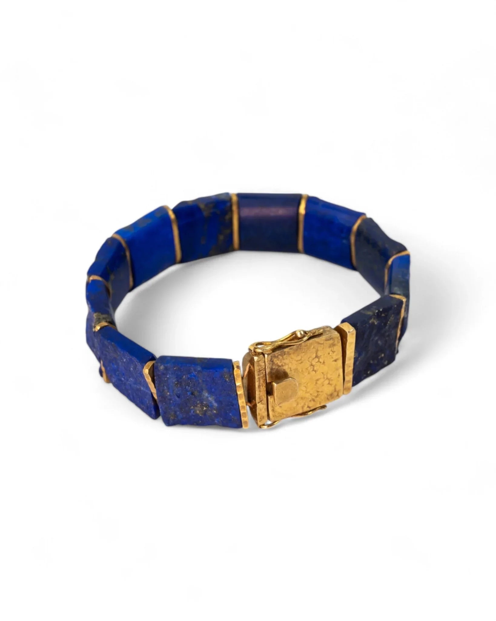 Chunky lapis lazuli and gold bracelet with rectangular blue stone links and hammered clasp