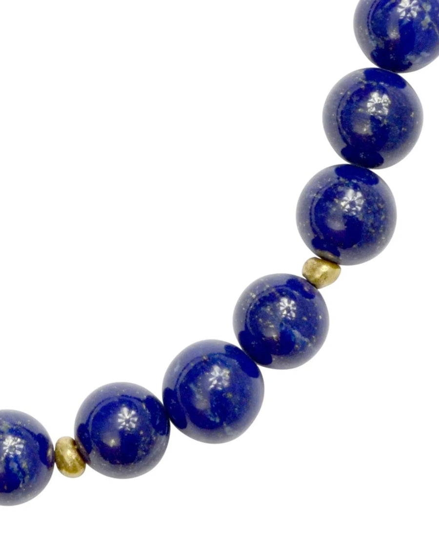 Lapis lazuli gold nugget necklace with round blue beads and small gold spacer beads.