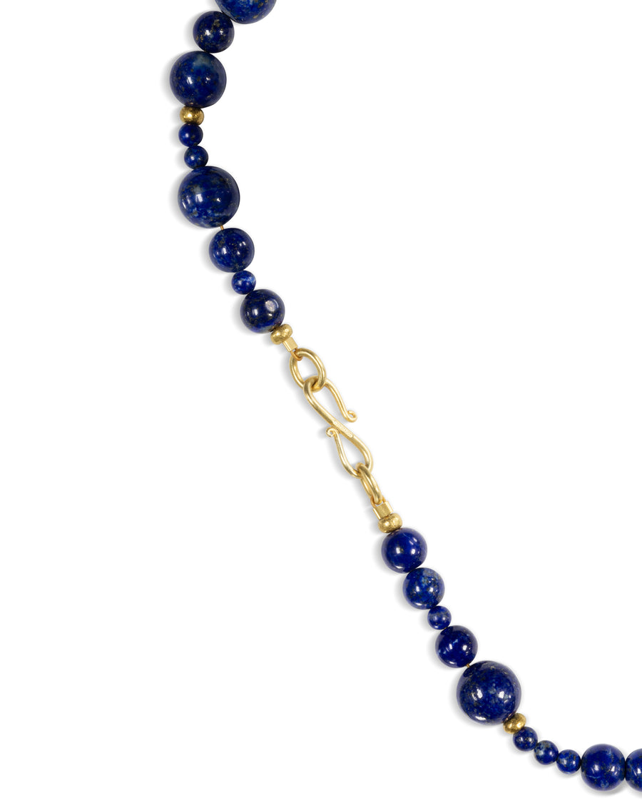 Lapis lazuli and gold nugget necklace with a gold hook clasp.