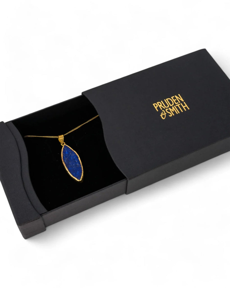 Gold marquise lapis lazuli pendant necklace displayed in a black gift box