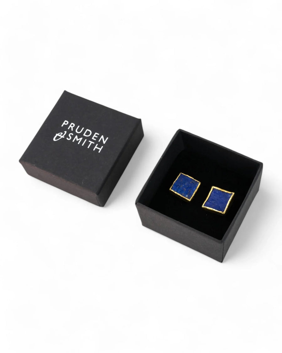 Blue lapis lazuli square stud earrings with gold trim in a black gift box