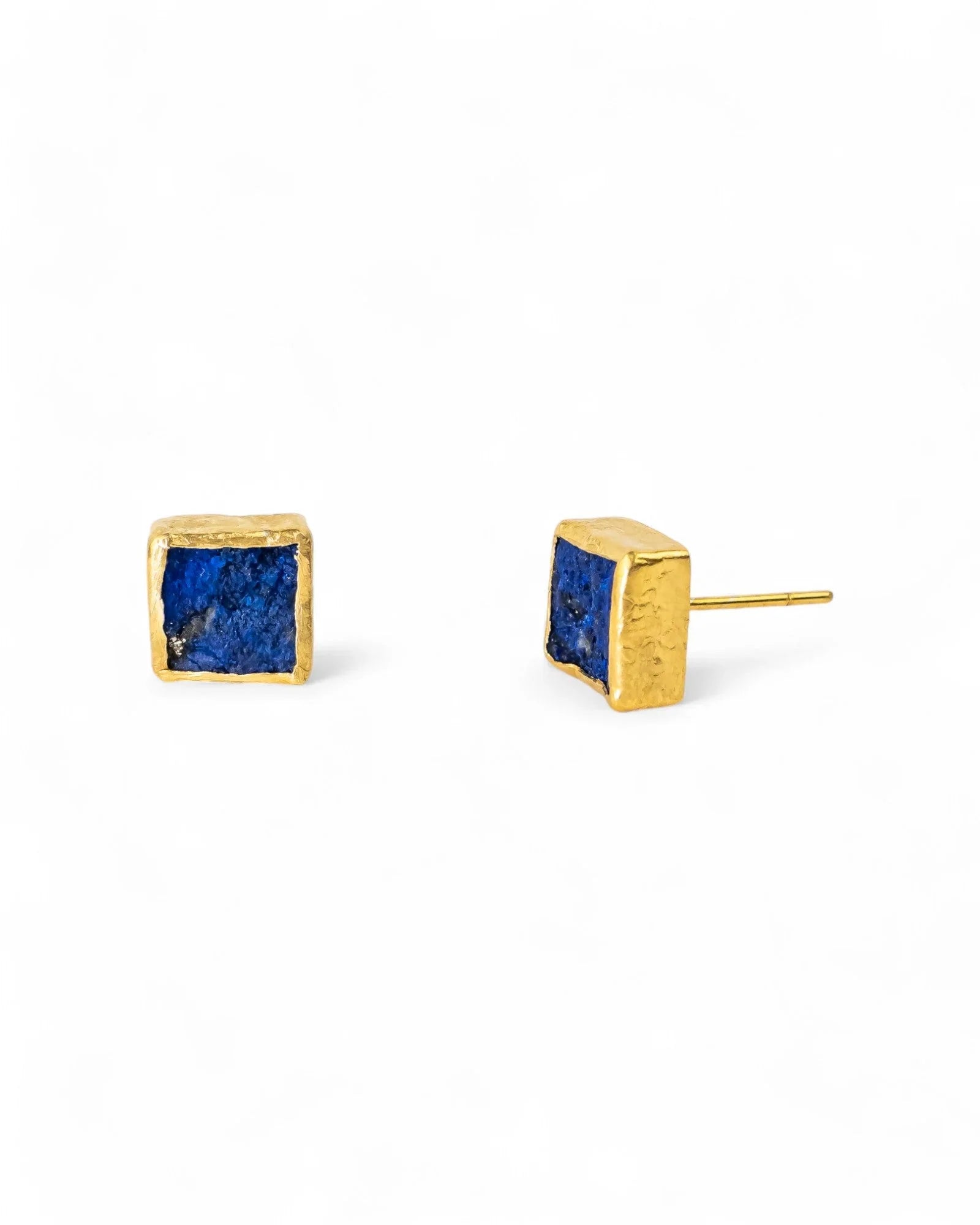 Lapis lazuli square stud earrings with gold textured setting on white background