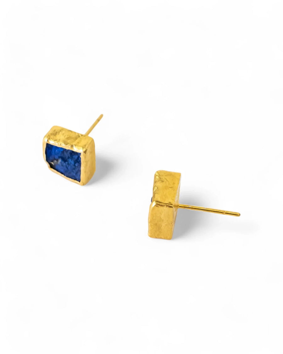 Gold stud earrings with square blue lapis lazuli stones on a white background