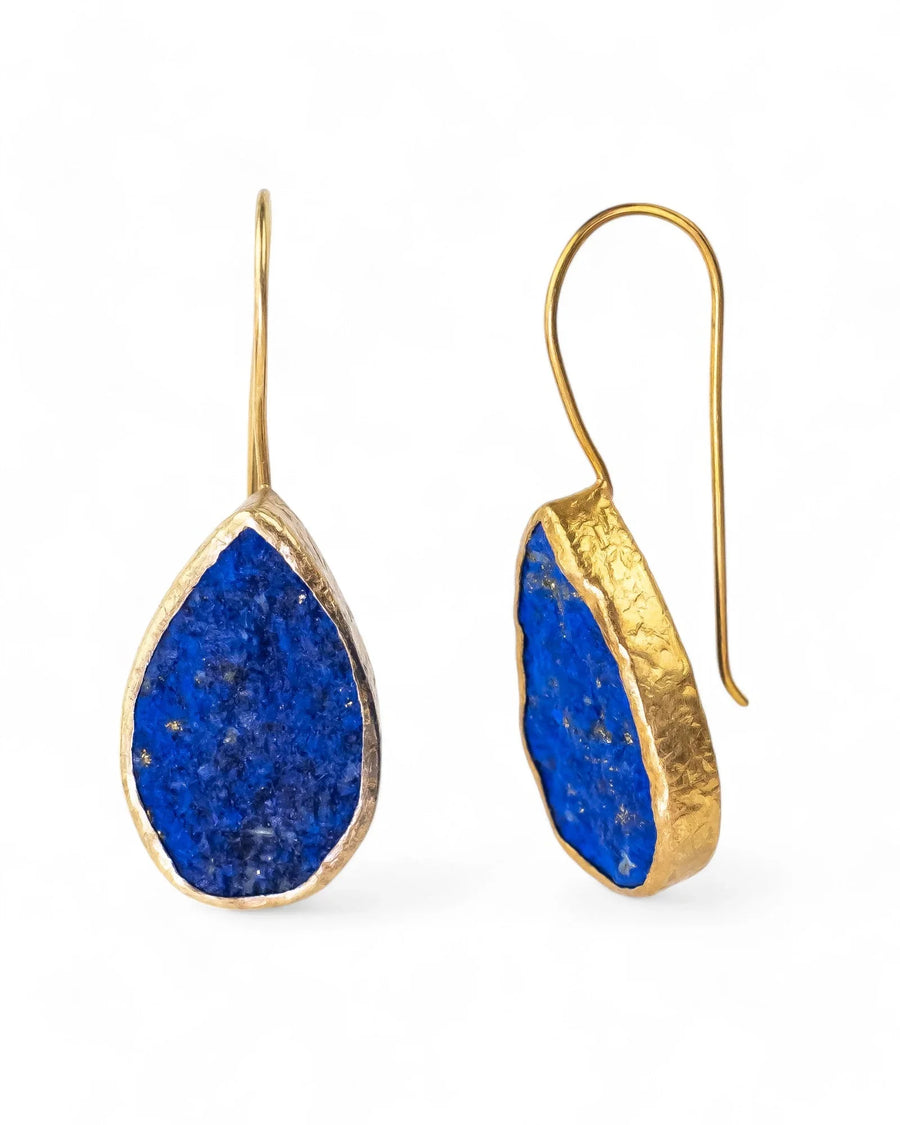 Teardrop lapis lazuli earrings with textured gold setting on white background