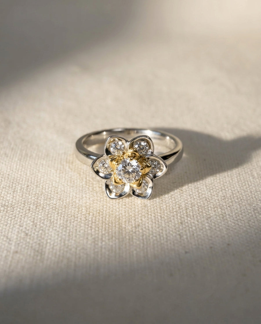 Platinum lotus flower ring with diamond cluster.