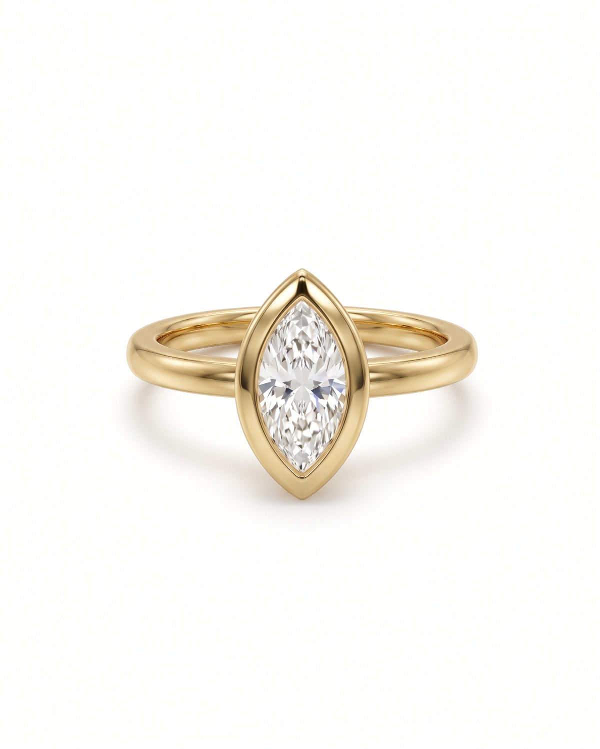 Marquise cut diamond engagement ring in a yellow gold bezel setting with a cathedral band.