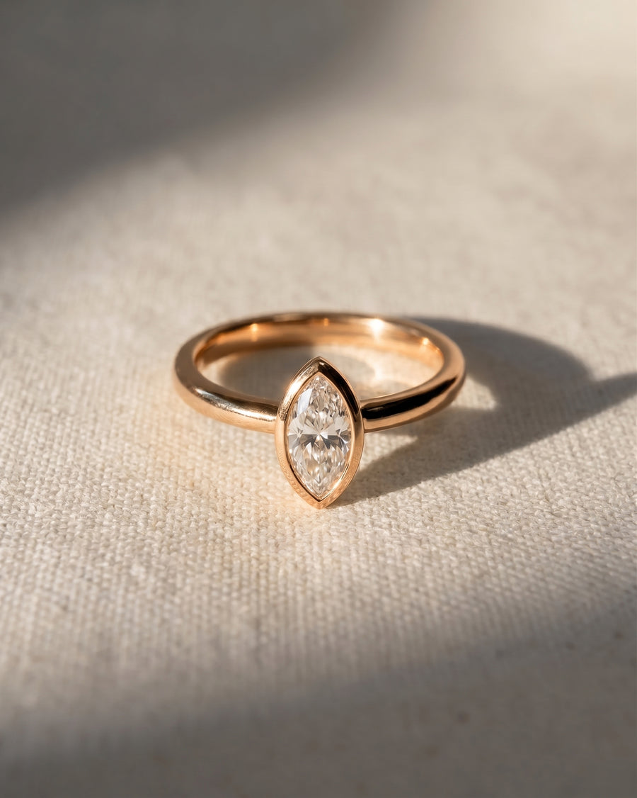 18ct rose gold engagement ring with a marquise cut lab-grown diamond in a bezel setting.