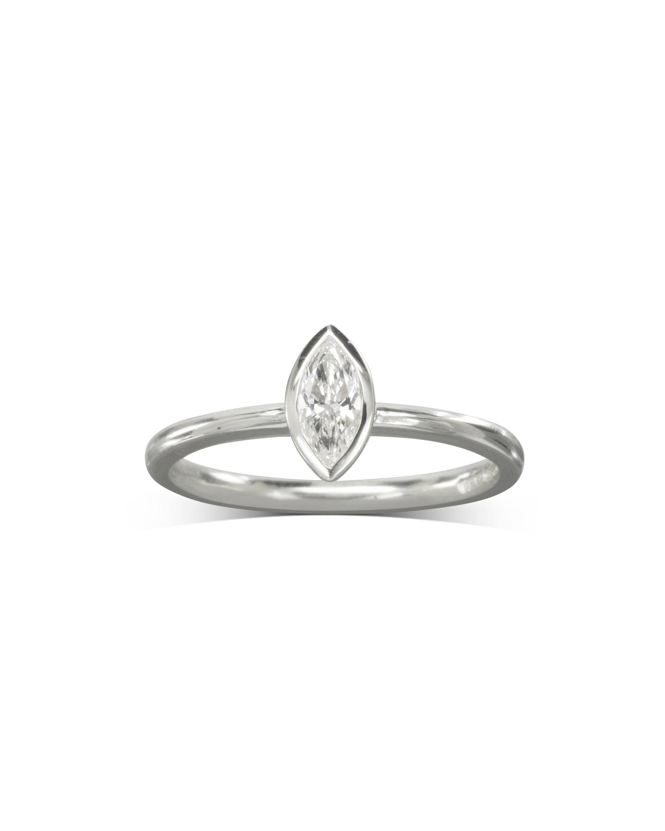 Silver ring with a marquise cut diamond in a bezel setting.