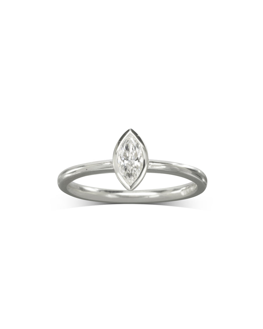 Silver ring with a marquise cut diamond in a bezel setting.