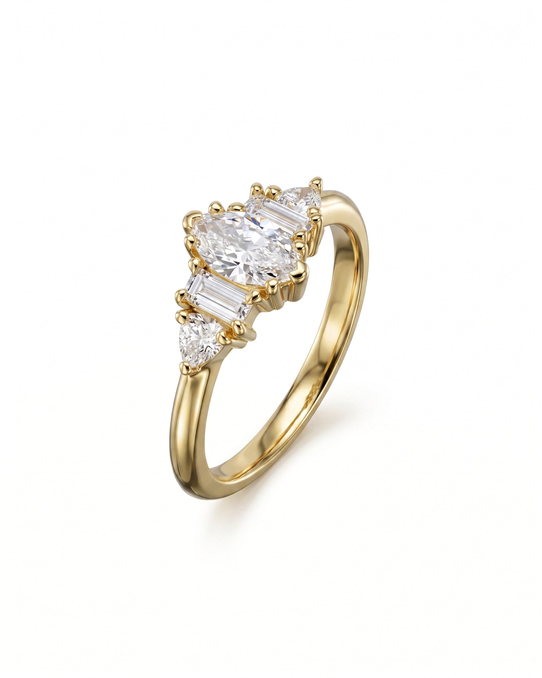 Gold engagement ring featuring a central marquise cut diamond with baguette and pear side stones.