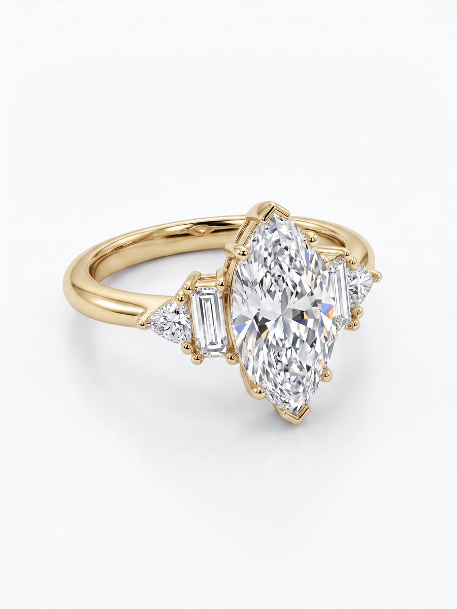 Gold engagement ring with a marquise cut diamond and claw side stones.