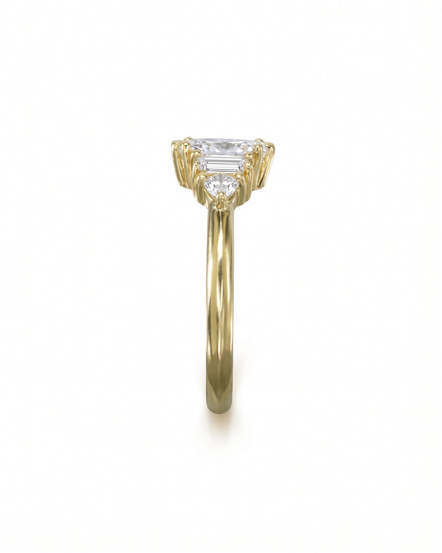 Gold engagement ring with a marquise cut center stone and baguette and round side diamonds.