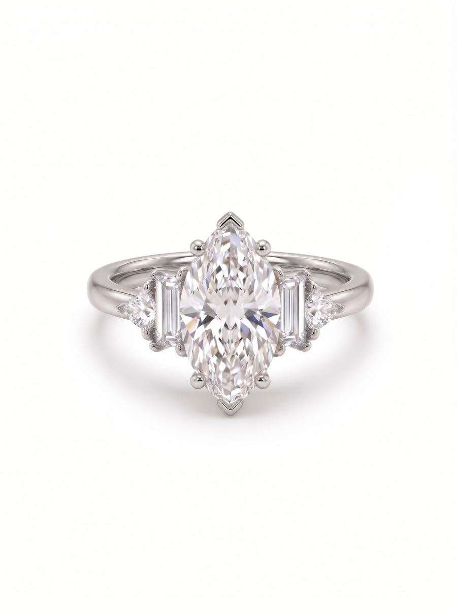 Platinum engagement ring featuring a central marquise cut diamond with baguette and trillion side stones.