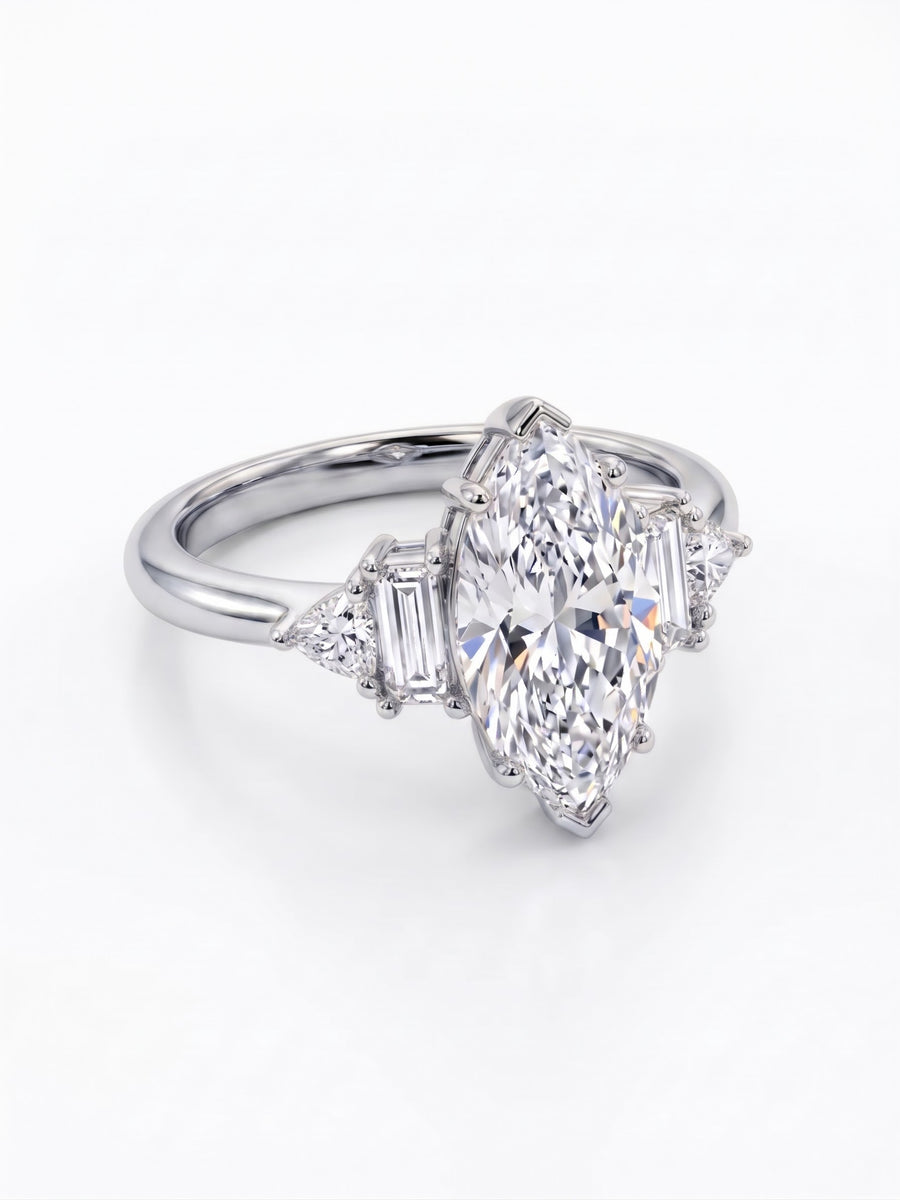 Marquise cut diamond engagement ring in platinum with baguette and trillion side stones on a polished band.