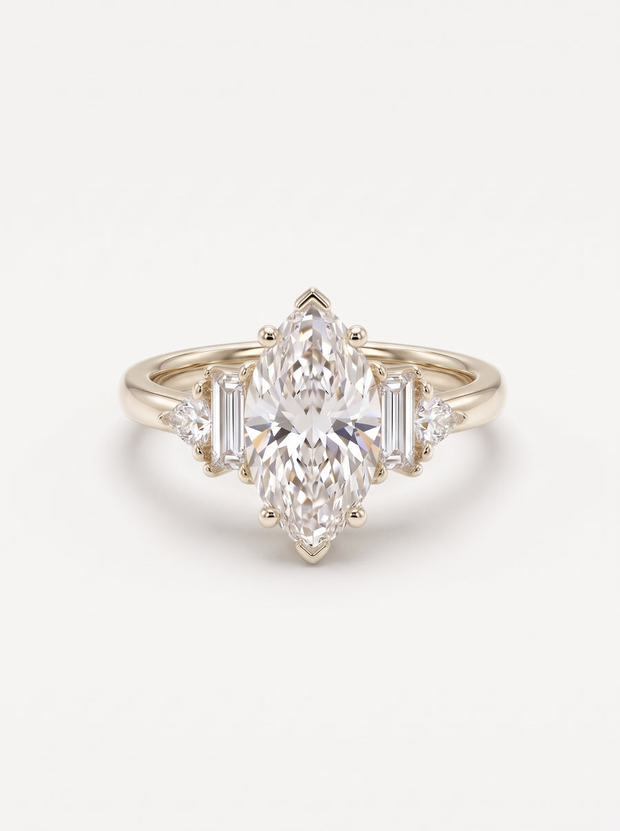 Gold engagement ring featuring a central marquise cut diamond with baguette and trillion side stones.