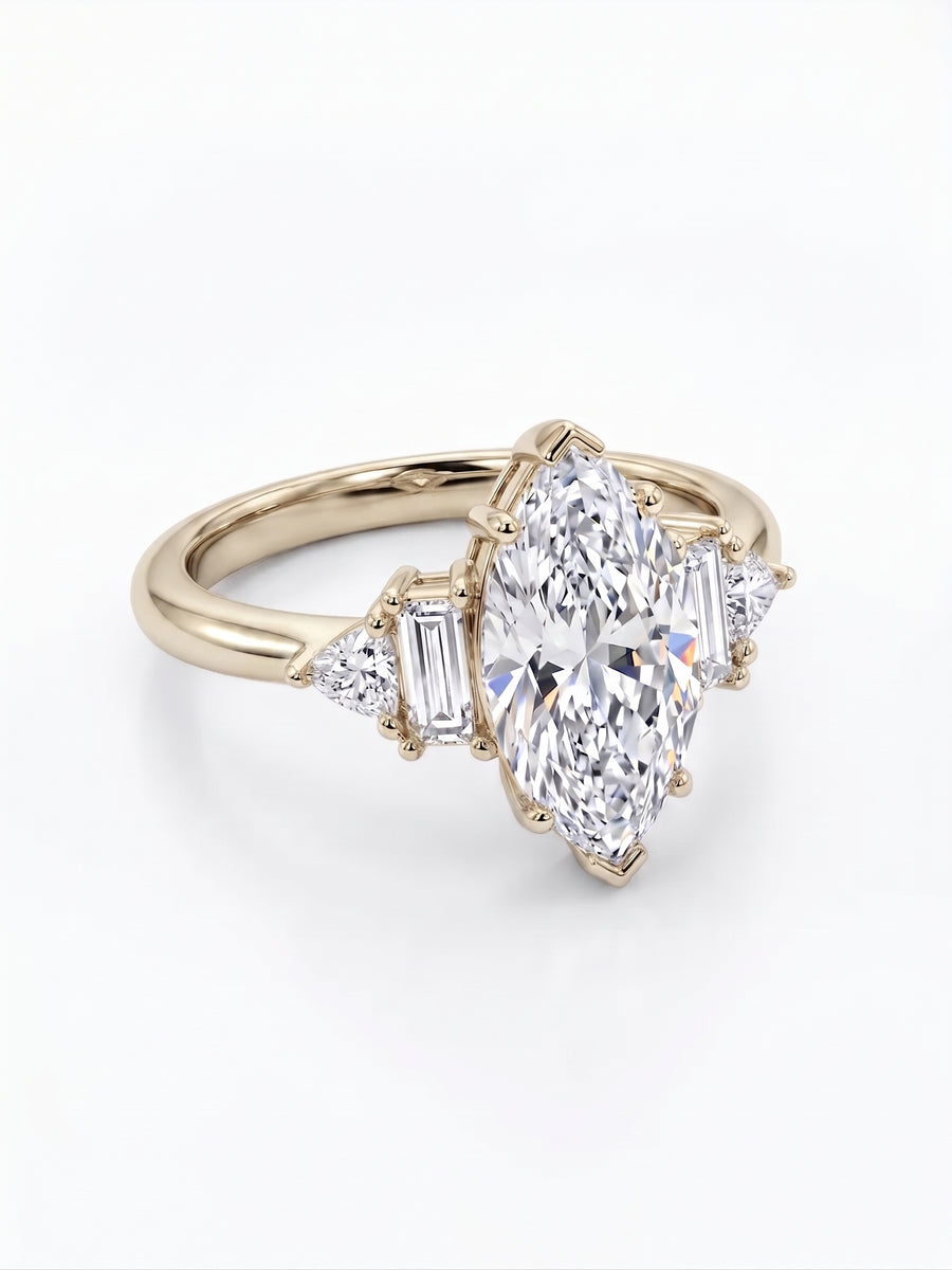 Gold engagement ring with a marquise cut center stone, baguette and trillion side diamonds.
