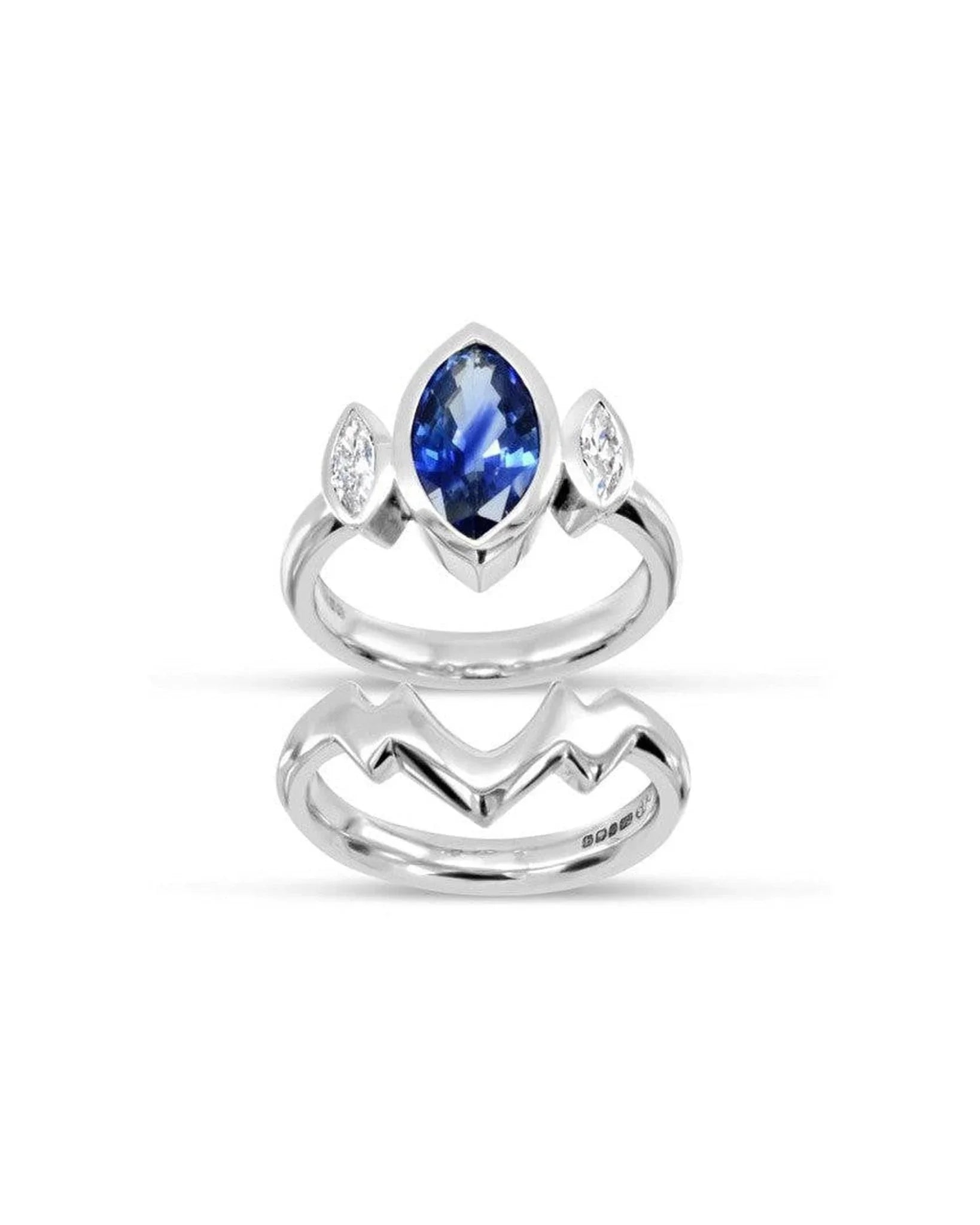Marquise-cut sapphire and diamond trilogy ring set in white gold with modern band design