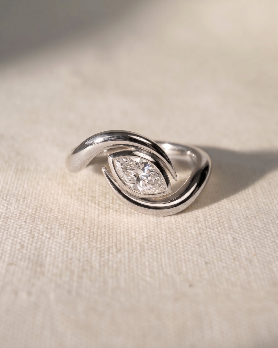 Silver marquise cut spiky engagement ring with a diamond.