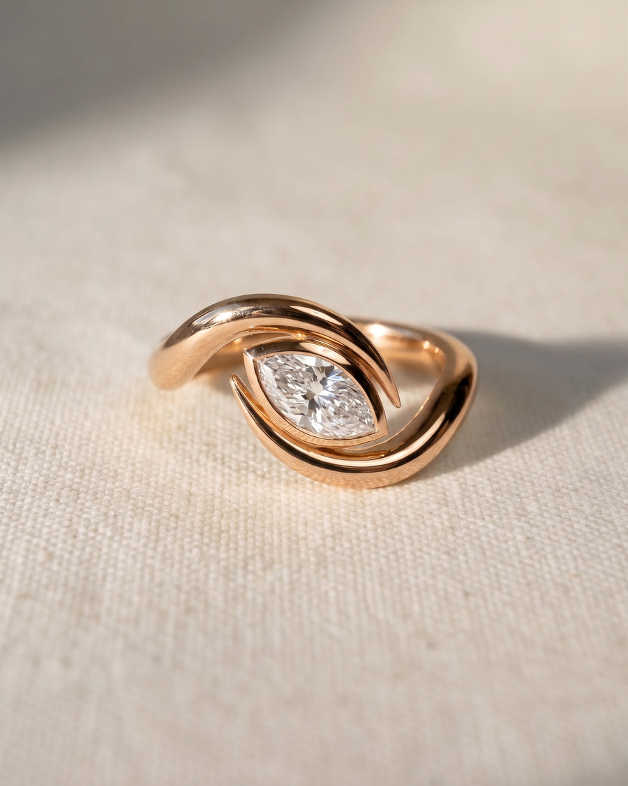 Rose gold marquise cut spiky engagement ring with a diamond.