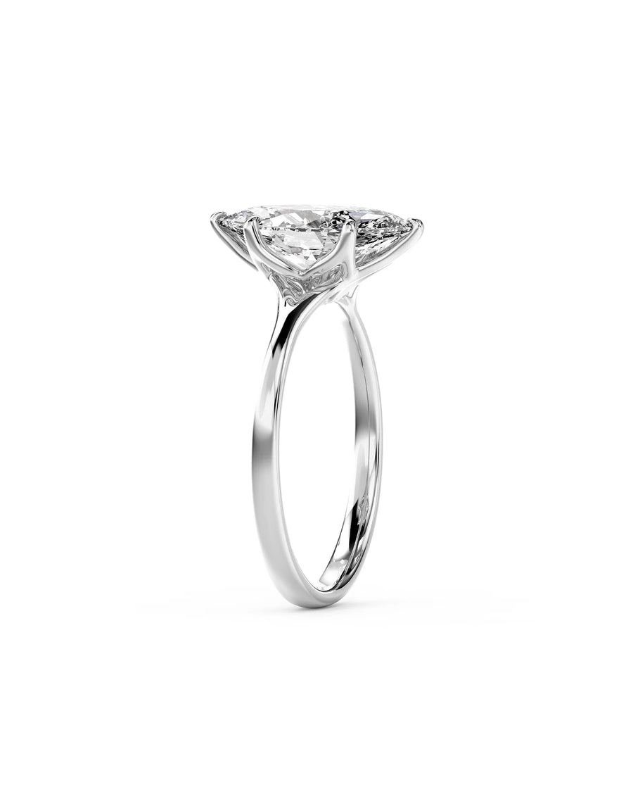 White gold engagement ring with a marquise cut diamond in a tulip claw setting.