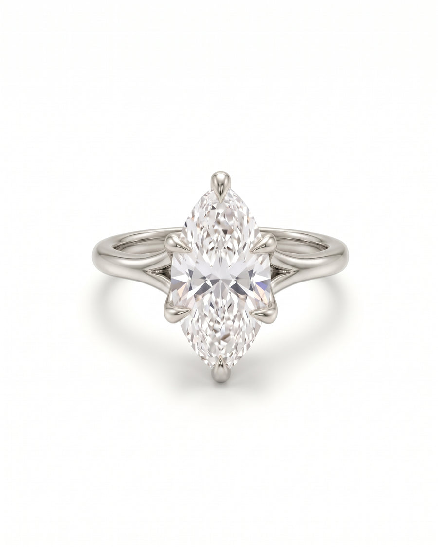 Marquise cut diamond engagement ring in a platinum tulip claw setting on a plain band.
