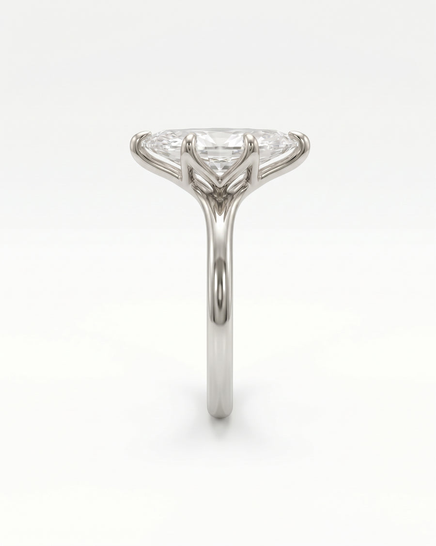Marquise cut diamond engagement ring in polished white gold with a tulip claw setting.