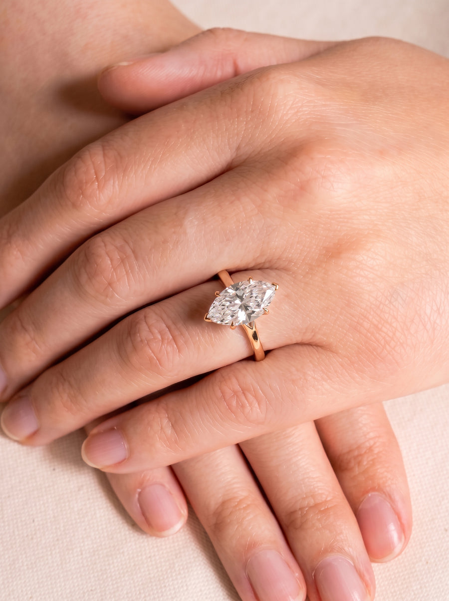 Marquise cut diamond engagement ring with a tulip claw setting on a rose gold band.