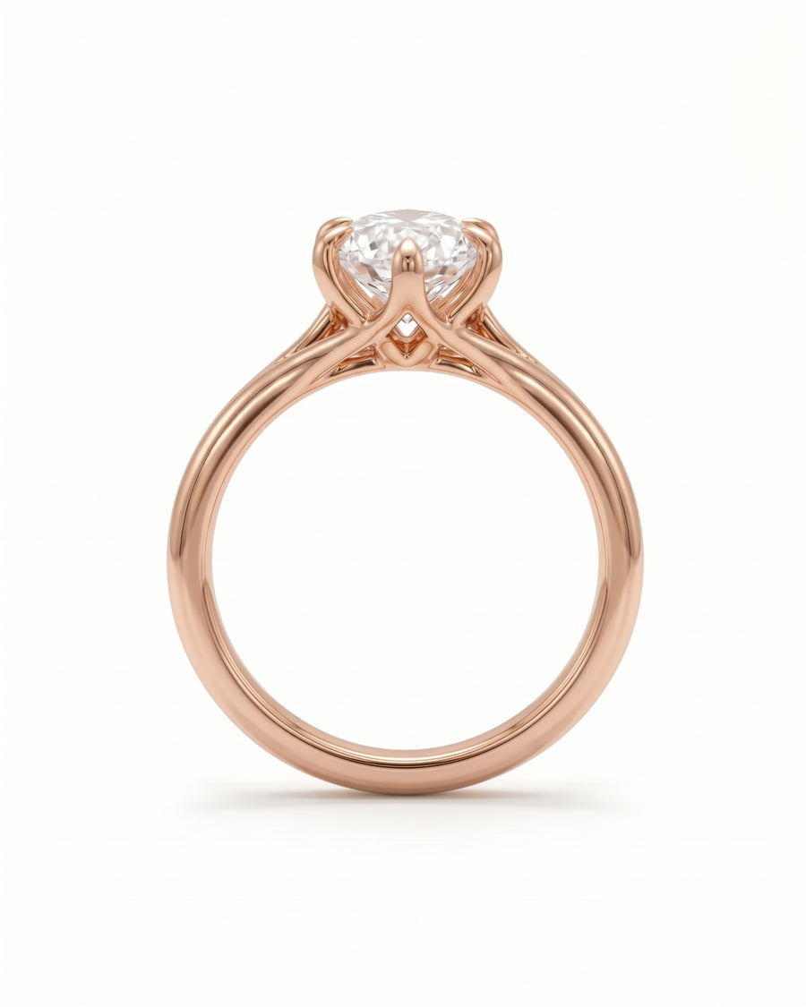 Rose gold engagement ring featuring a marquise cut diamond in a tulip-style claw setting.