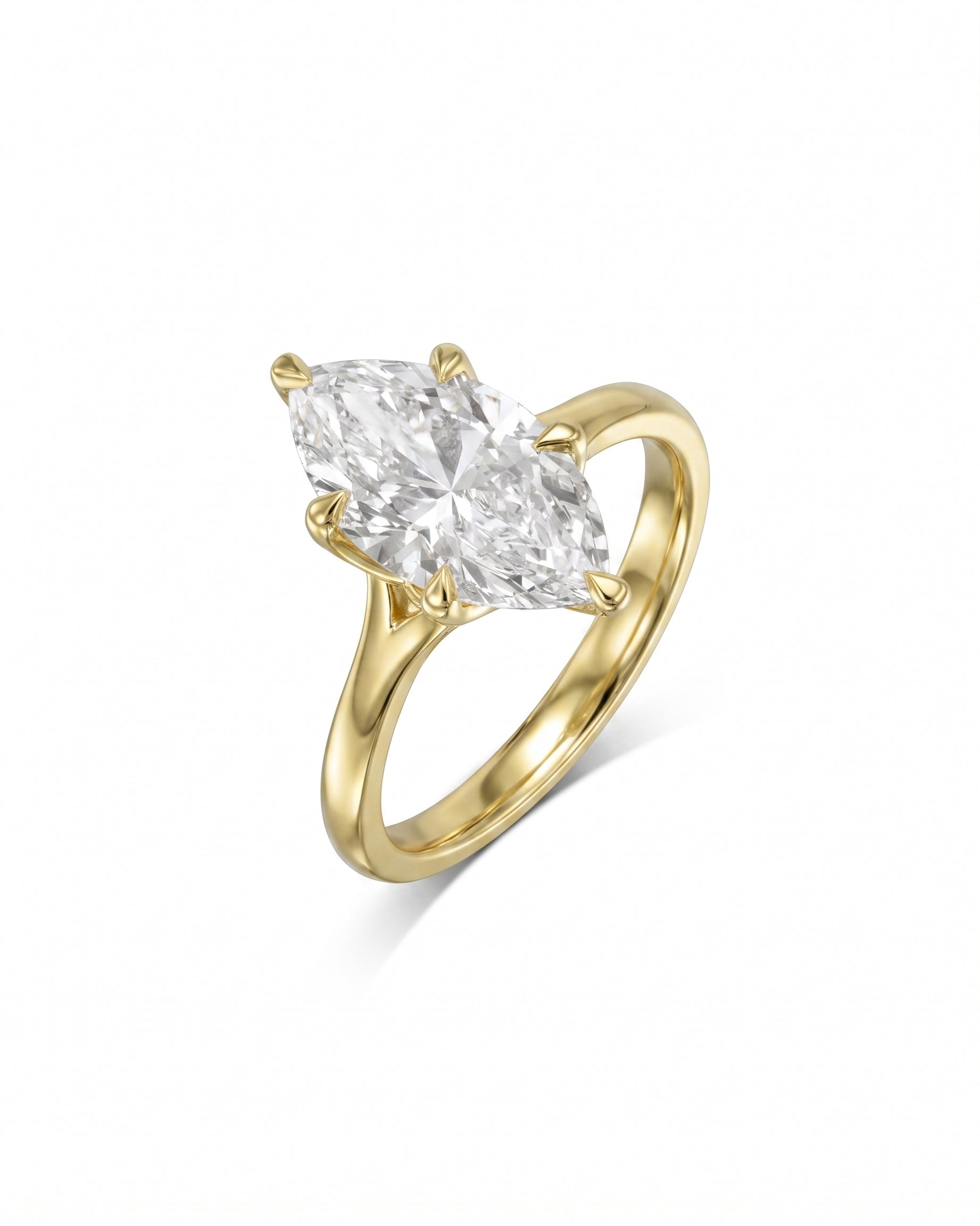 Yellow gold engagement ring with a marquise cut diamond in a tulip claw setting.
