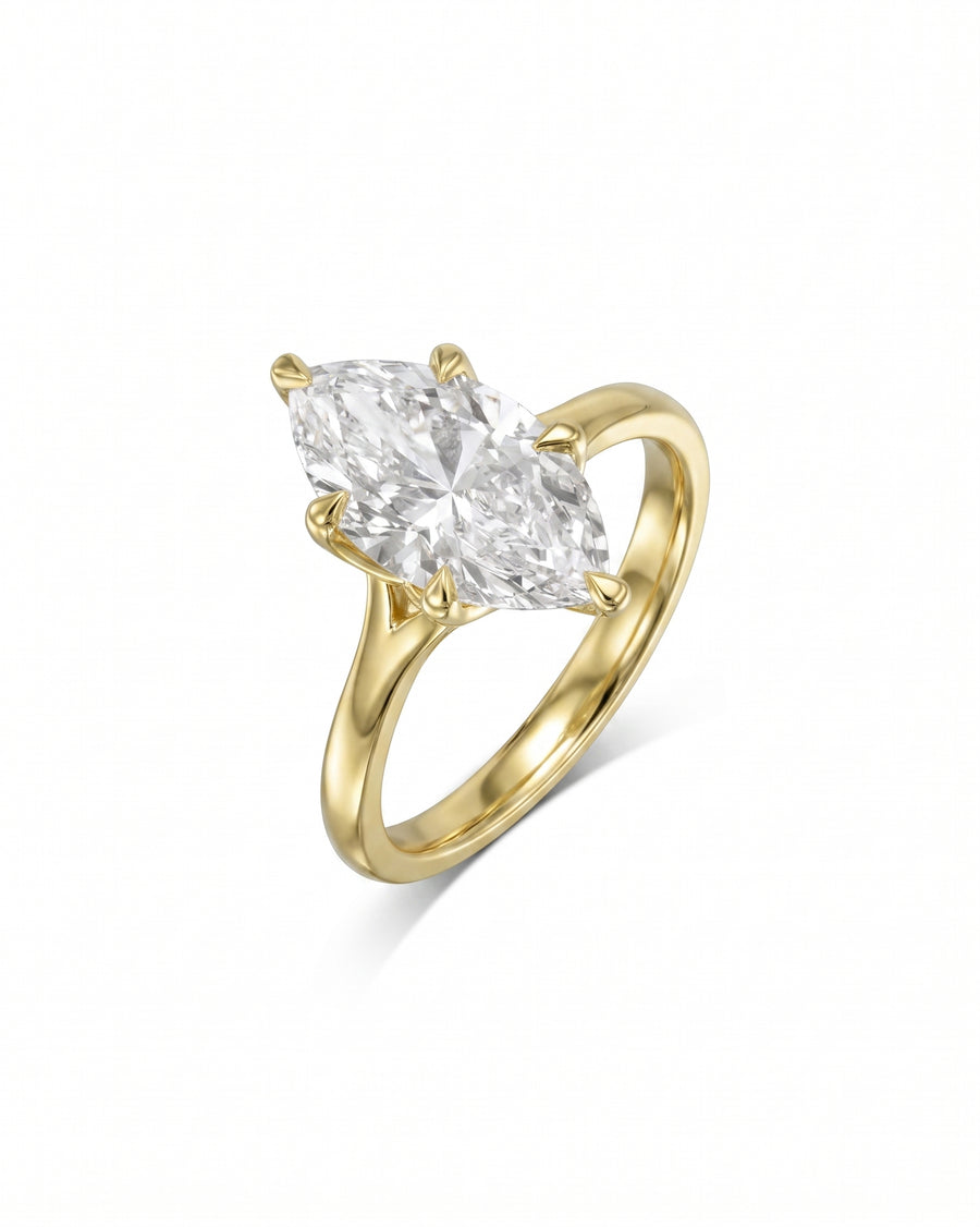 Marquise cut diamond engagement ring set in a yellow gold tulip claw setting.