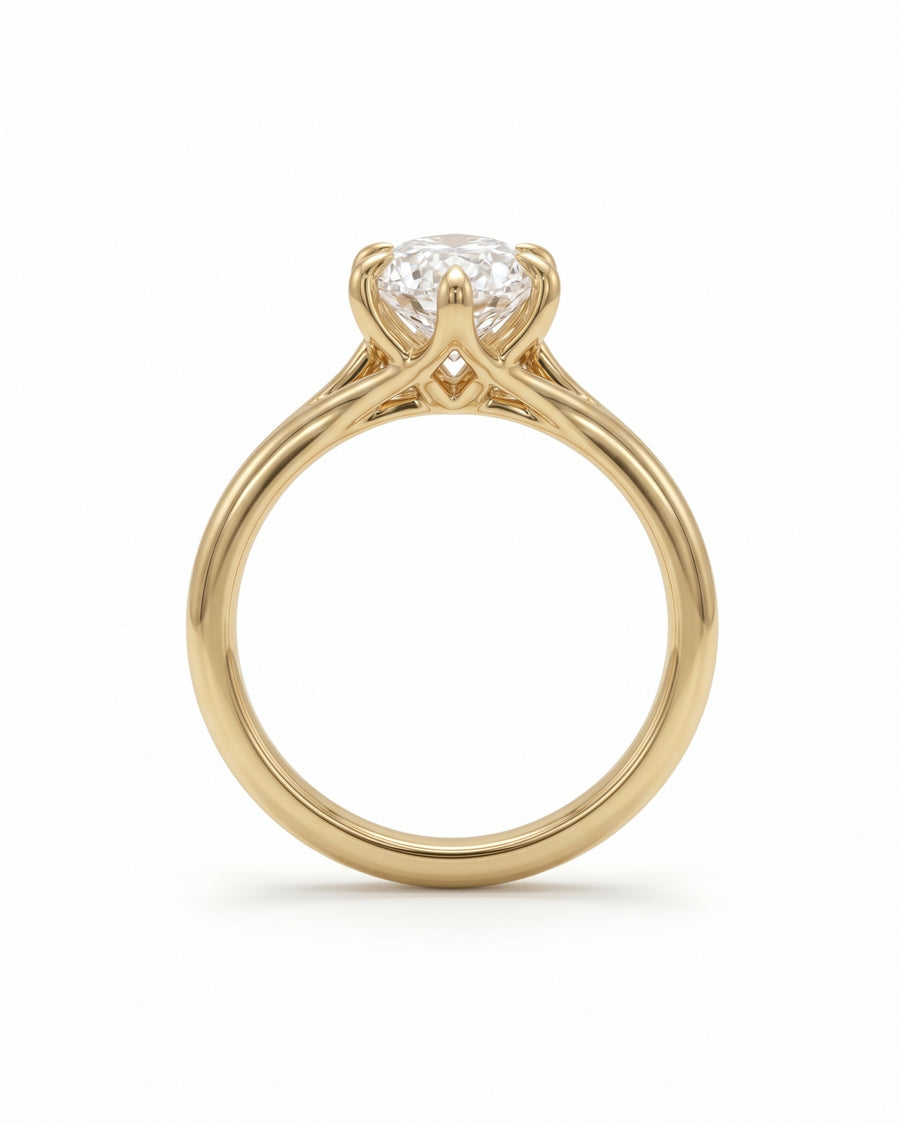 Gold engagement ring with a marquise cut diamond in a tulip-style claw setting.