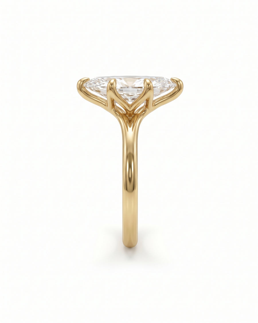 Marquise cut diamond engagement ring in yellow gold with a tulip-style claw setting.