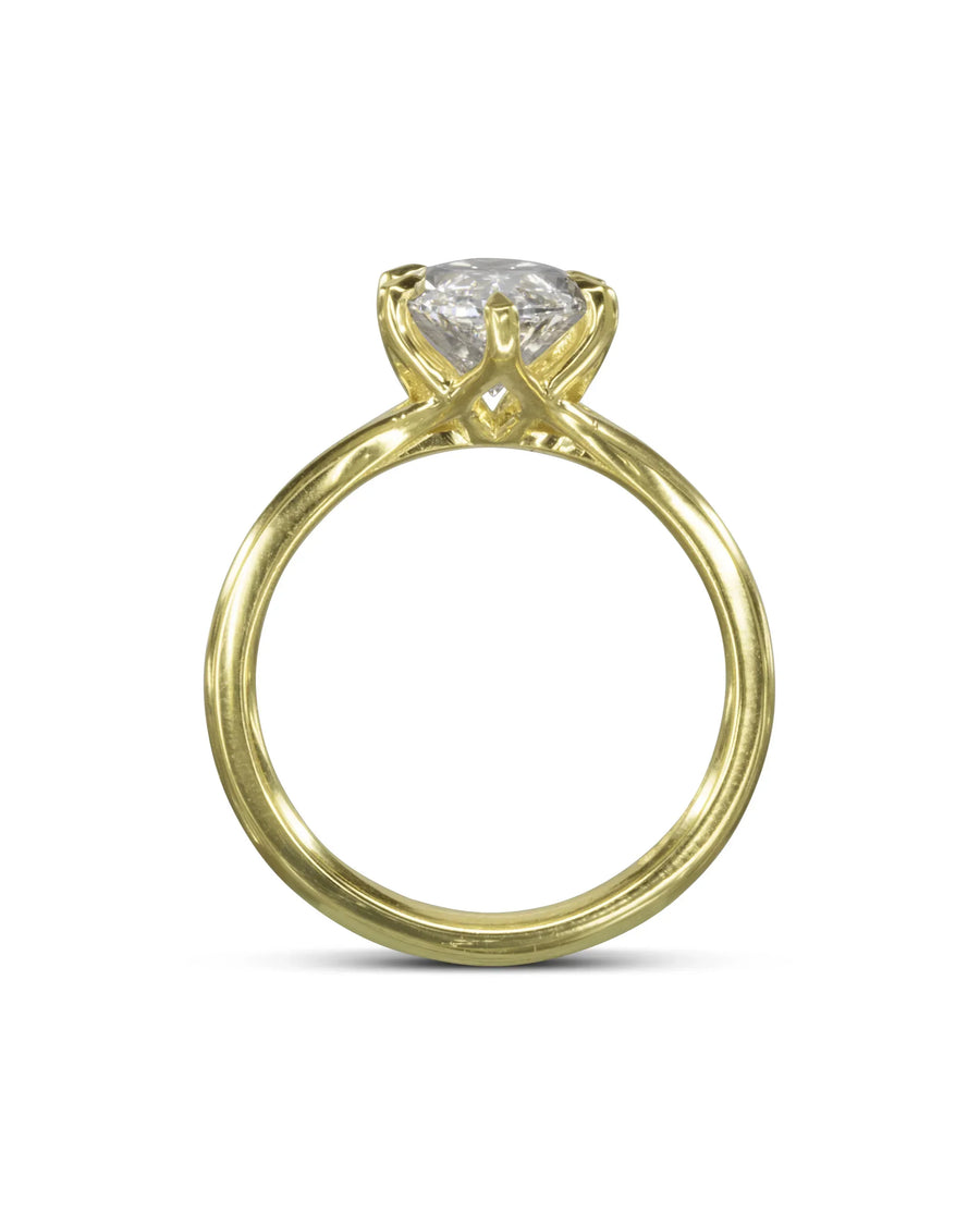 Marquise cut diamond engagement ring set in a yellow gold band with a tulip-style claw setting.
