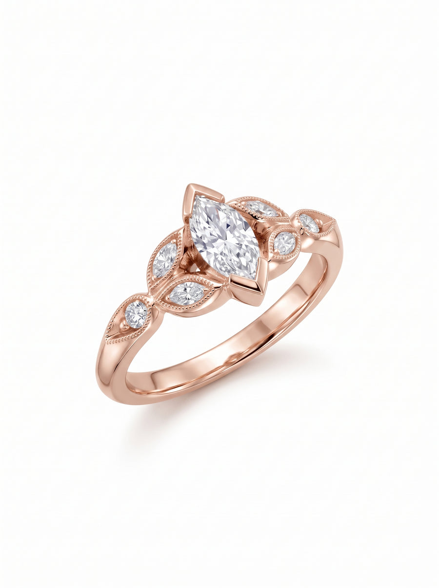 Rose gold engagement ring featuring a marquise cut center diamond with smaller accent stones on the band.