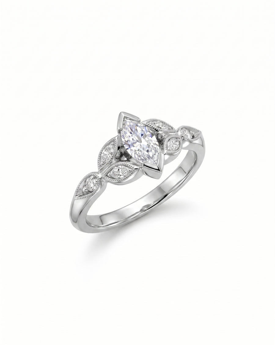 White gold marquise cut vintage engagement ring with diamond accents.