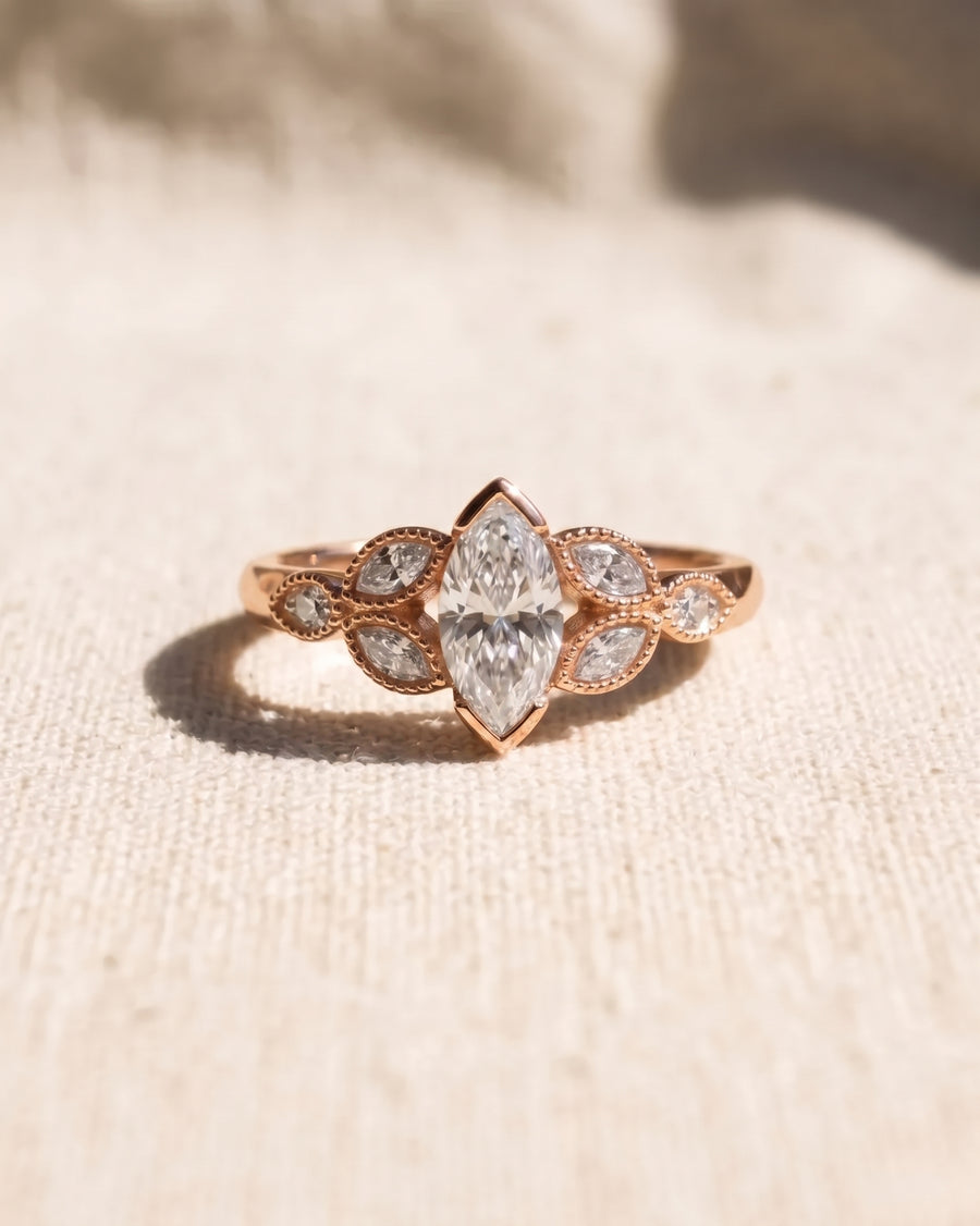 18ct rose gold marquise cut engagement ring with a 1ct lab-grown diamond and leaf-shaped side stones.