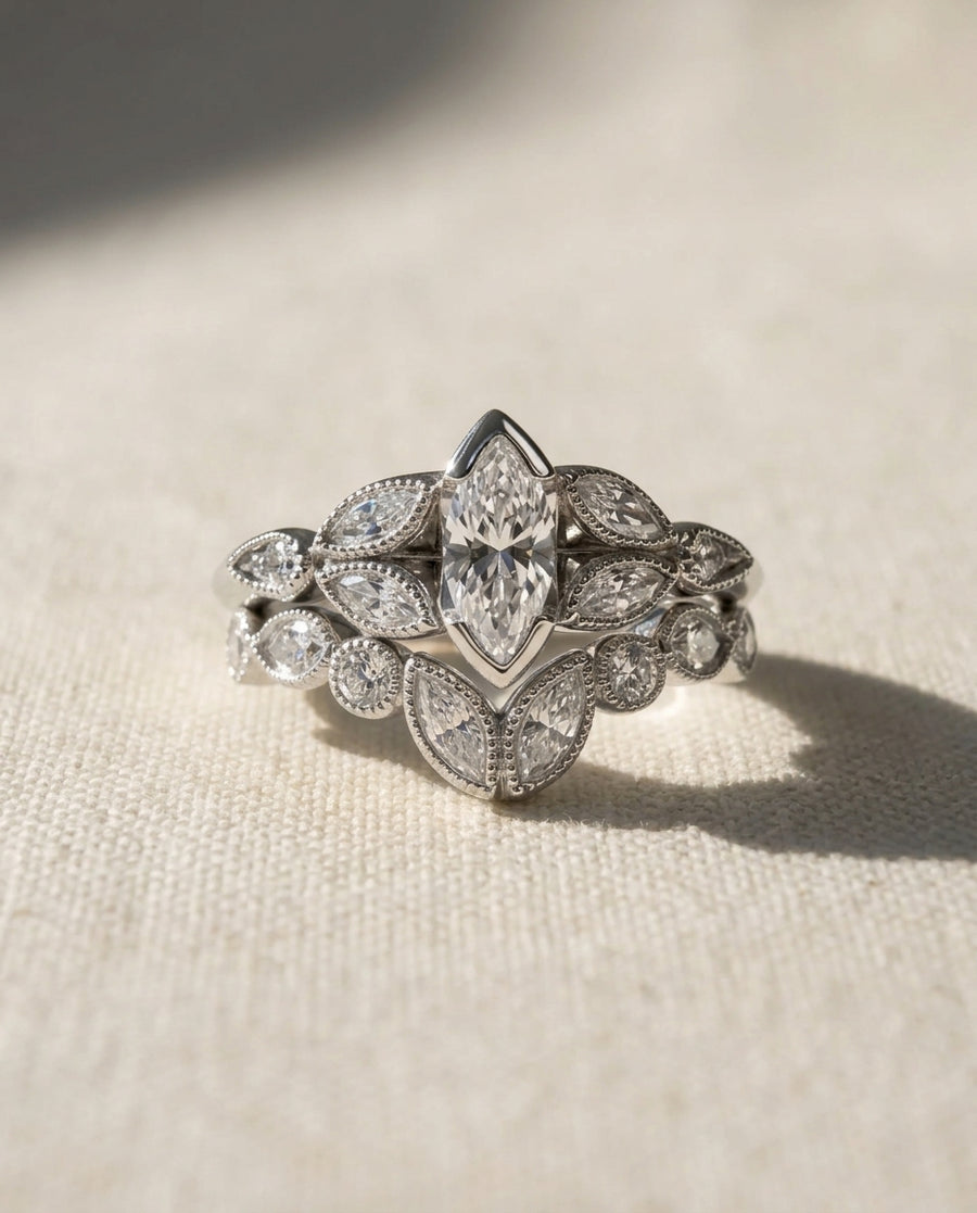 Platinum marquise diamond beaded wedding and engagement ring set.