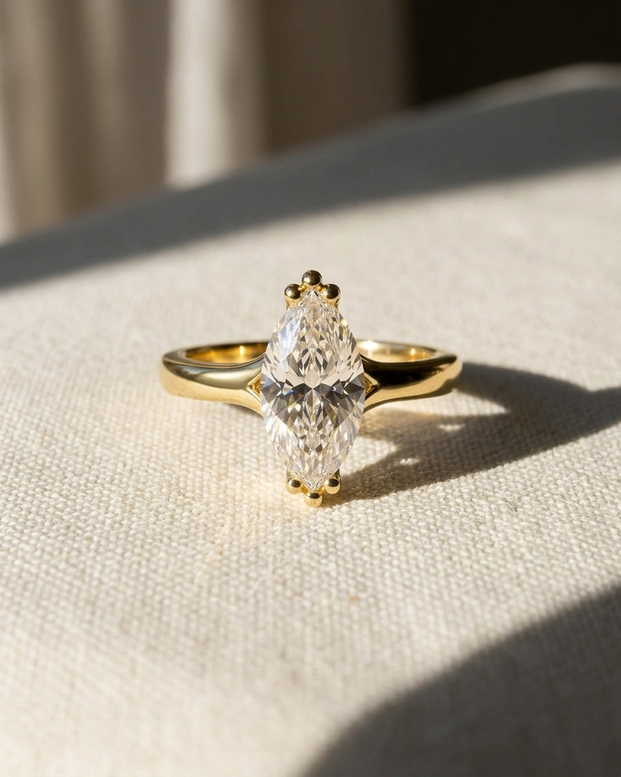 18ct yellow gold engagement ring with a marquise-cut natural diamond.