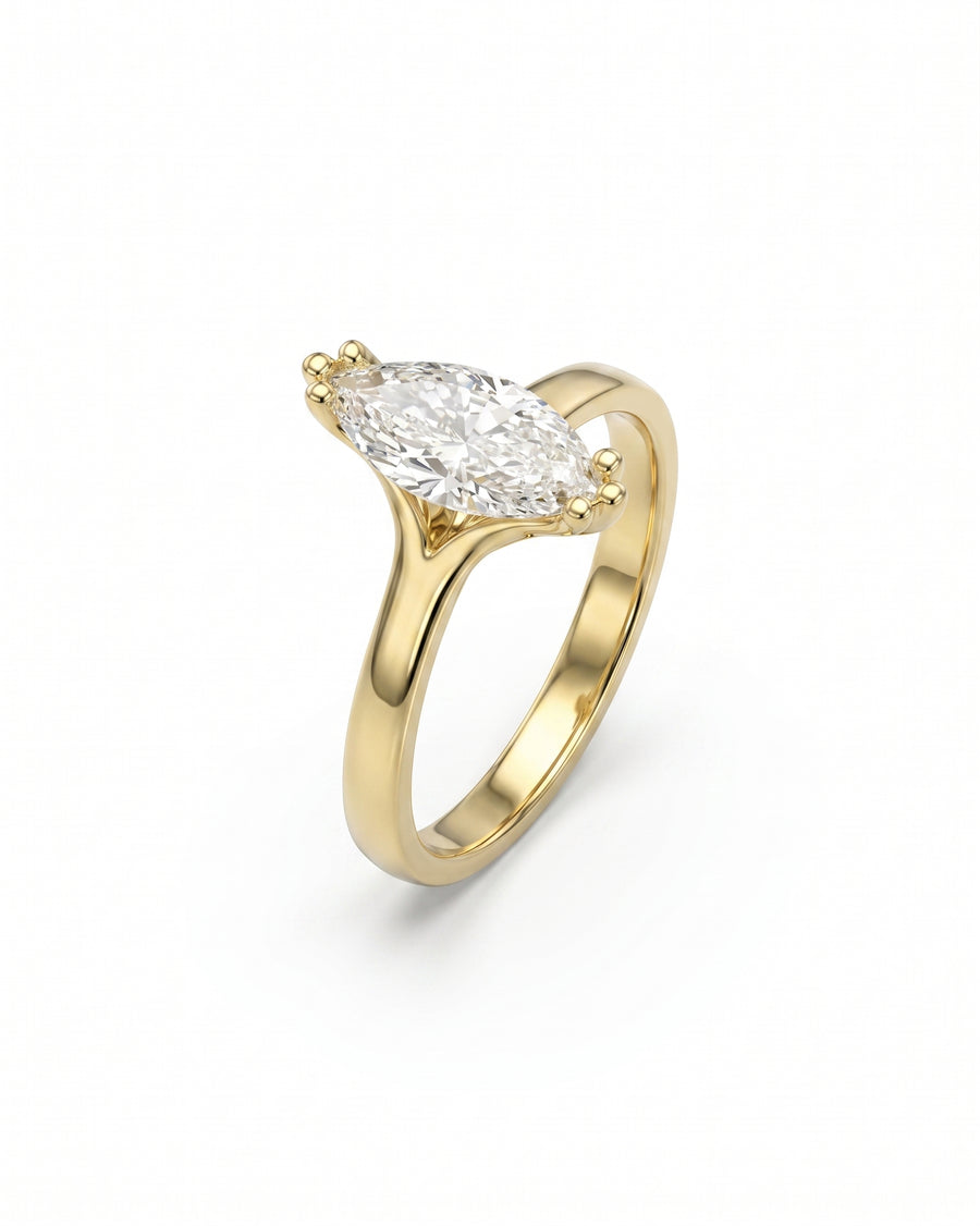Gold engagement ring with a marquise diamond.
