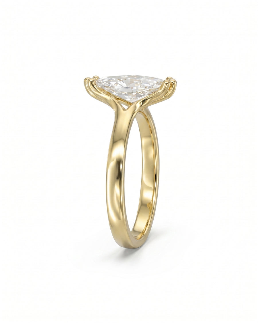 Yellow gold engagement ring with a marquise diamond.