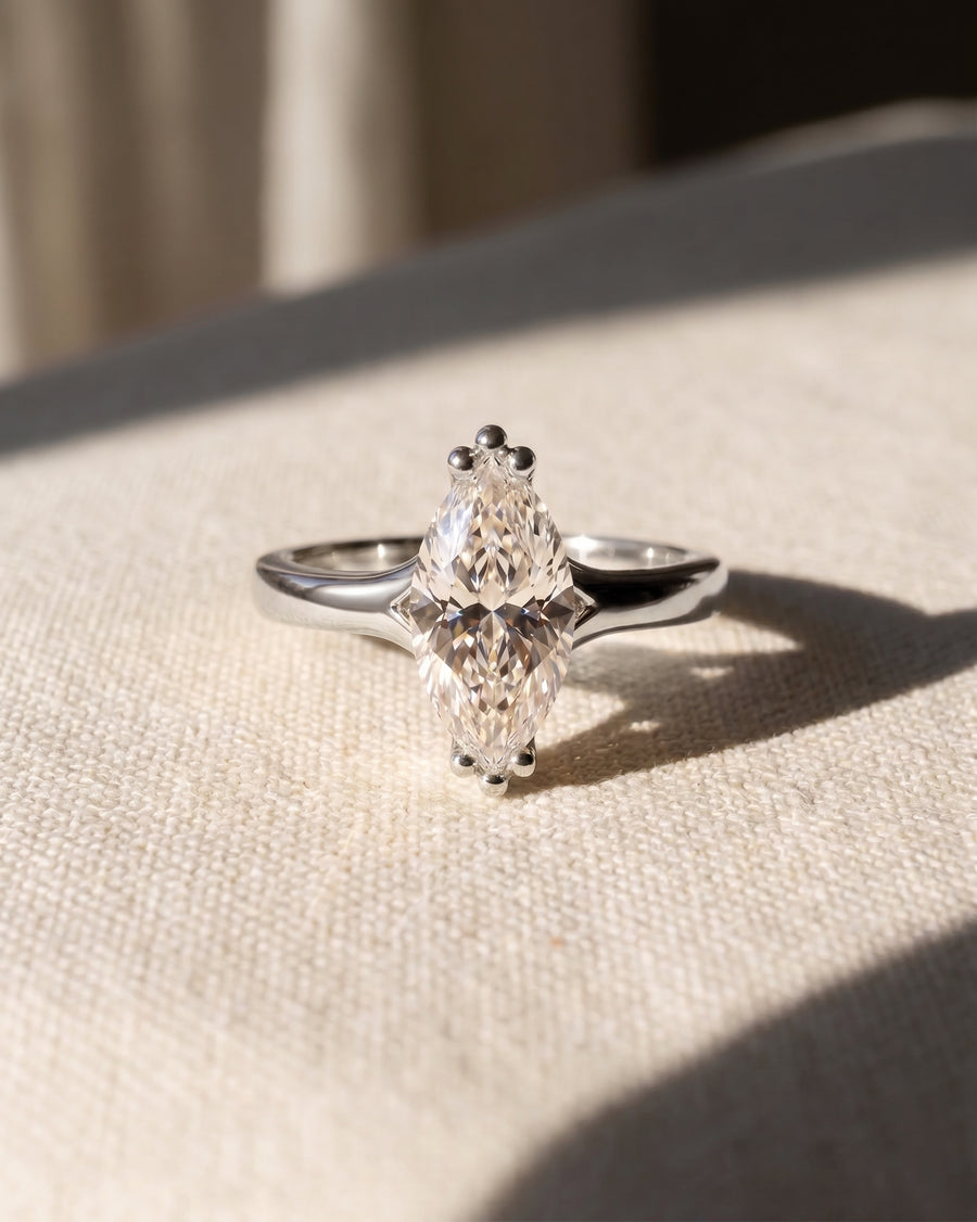 Platinum engagement ring with a marquise-cut natural diamond.