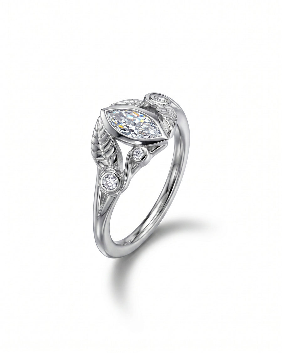 Silver ring with a marquise diamond center stone and floral leaf accents.
