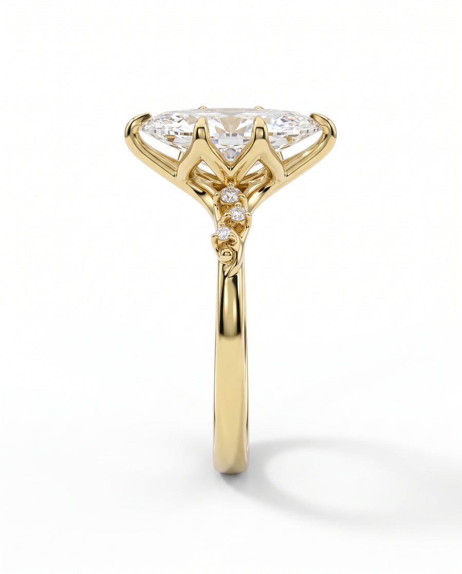 Marquise lab-grown diamond engagement ring in yellow gold with a floral vine setting and accent stones.