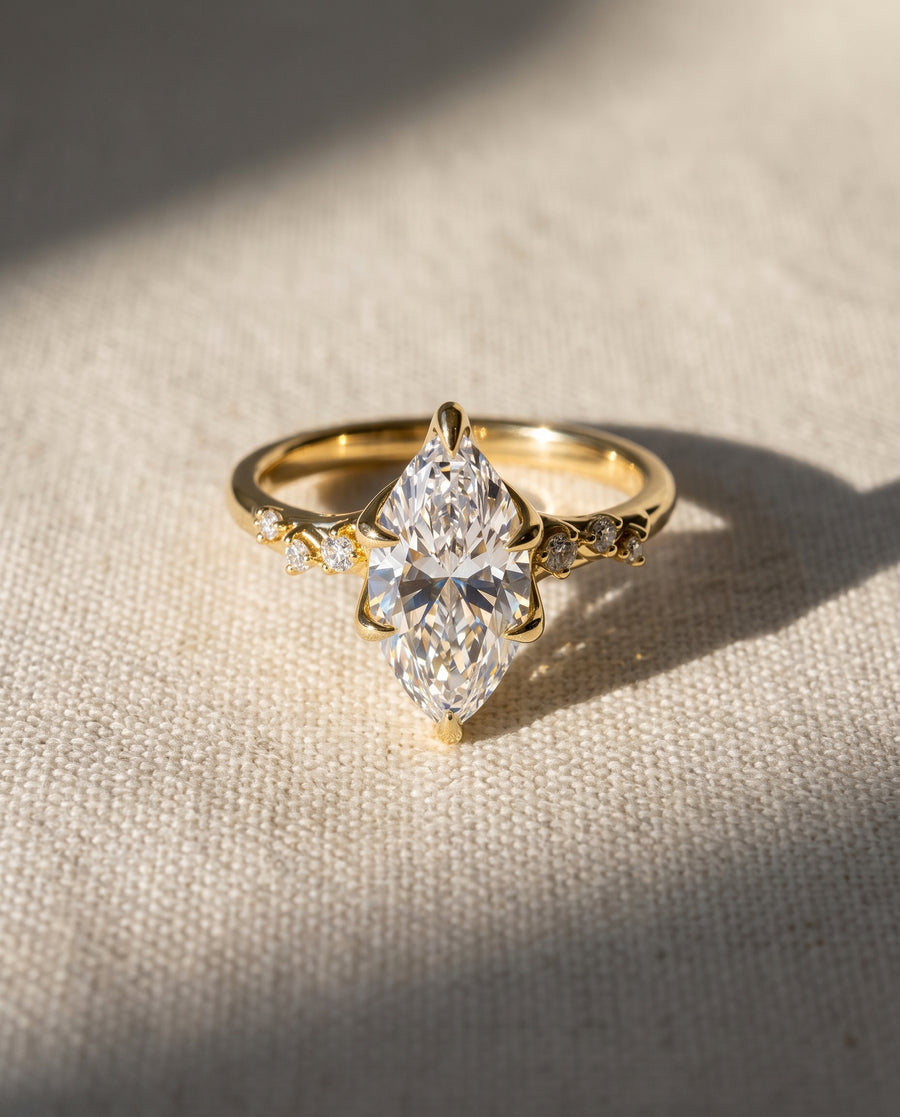 Marquise lab-grown diamond engagement ring in 18ct yellow gold with a floral vine design and side stones.