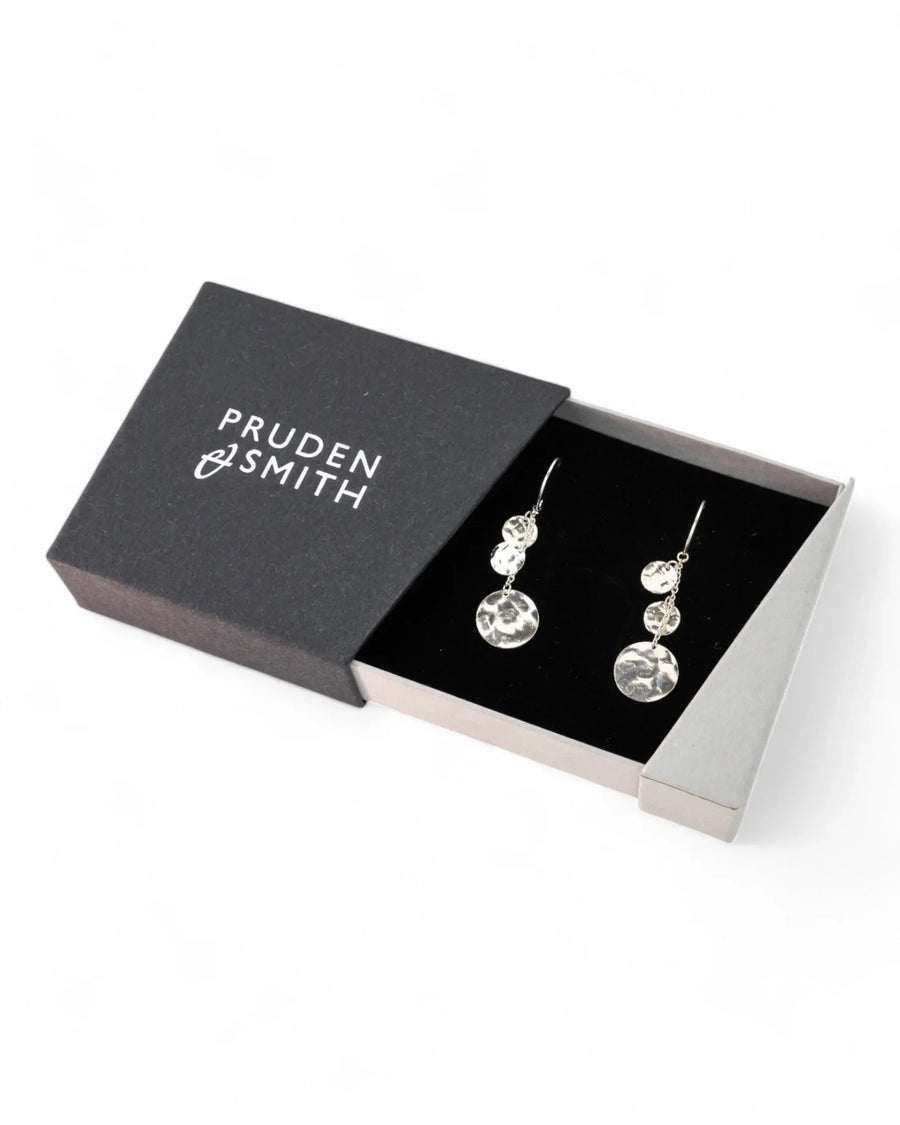 Handmade hammered silver disc dangly earrings in an open black gift box