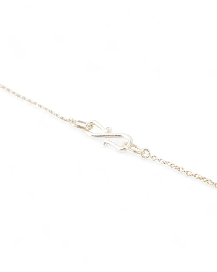 Delicate silver chain necklace with handcrafted S-hook clasp on white background